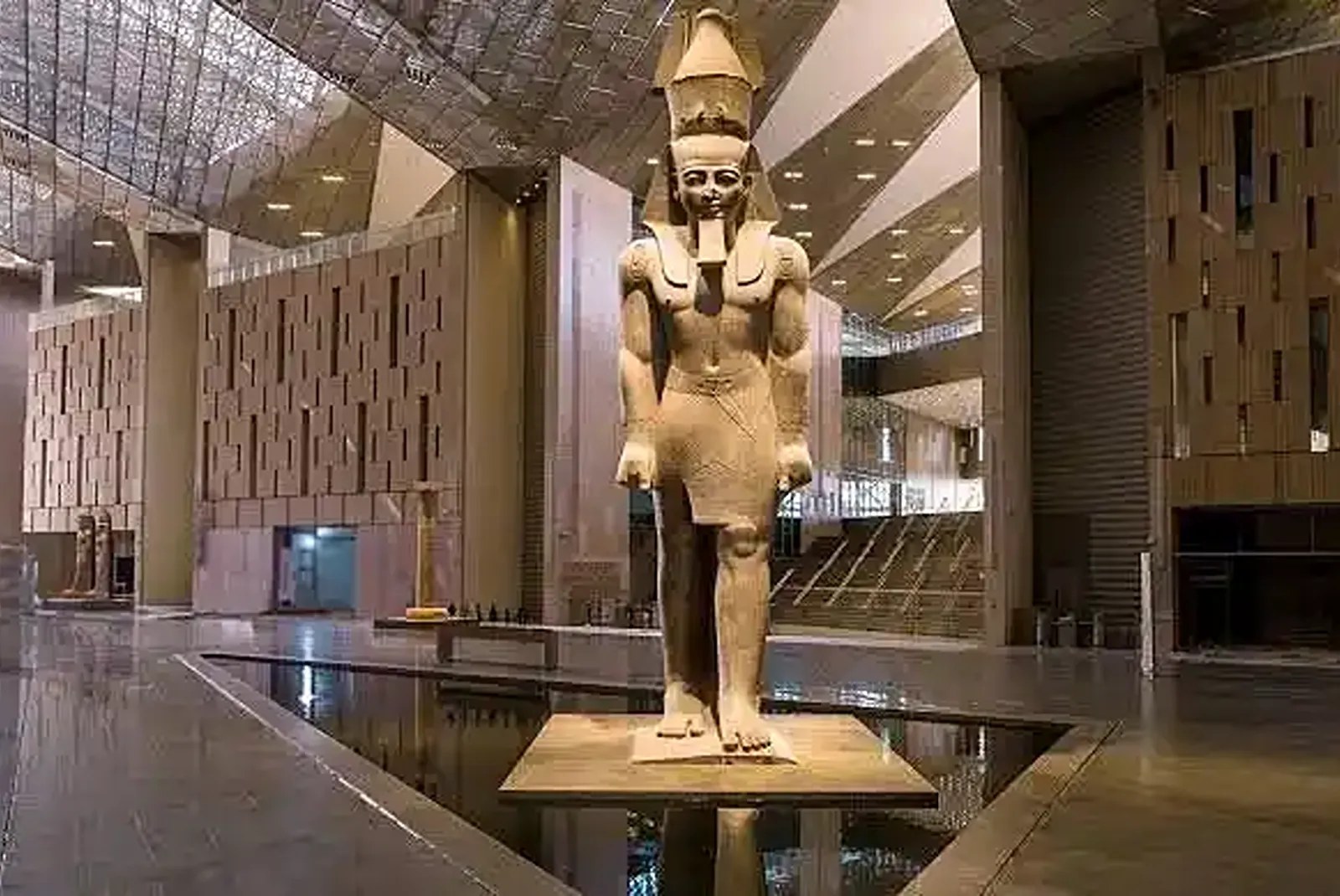 Monumental ancient Egyptian statue inside the Grand Egyptian Museum